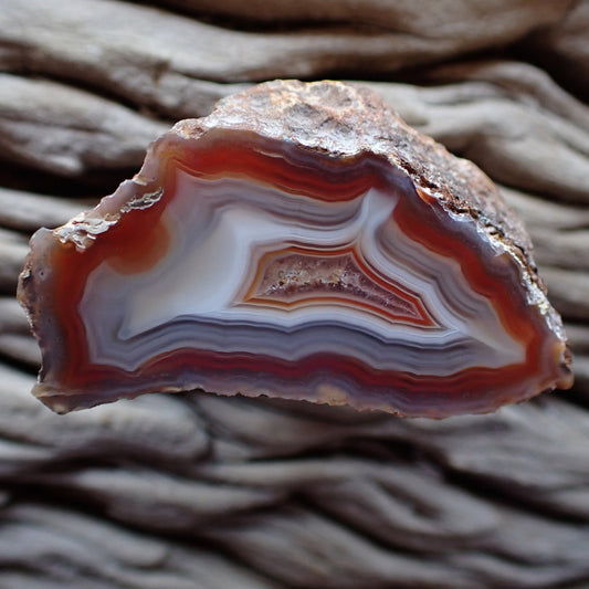 Stunning Malawi agate from the Ngabu region with ghost banding and a clear well defined flow channel, lovely colour contrasts of orange, white and red