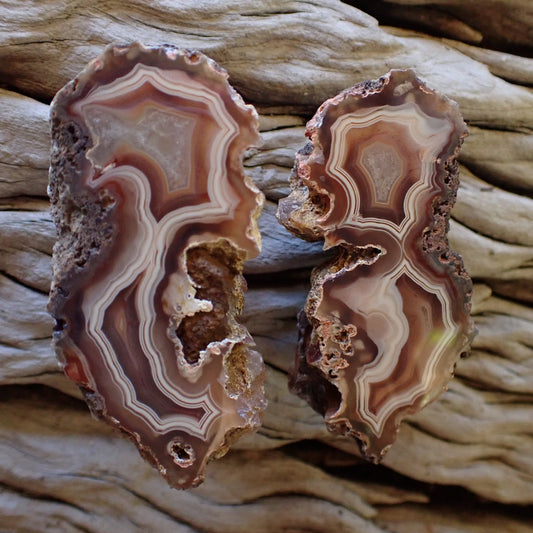 Natural hand-polished Malawi agate pair 57 mm & 56 mm – full specimens, matched pair with open vug cavities and fortification banding, Ngabu deposit