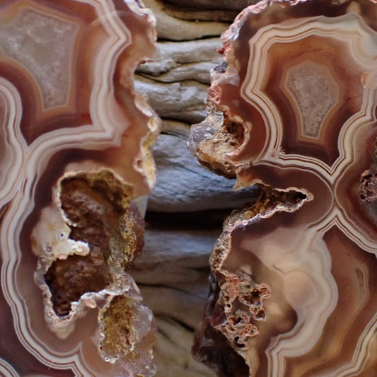 Close-up of Malawi agate pair 57 mm & 56 mm – vug cavities with druzy interiors, shadow banding and fortification banding detail