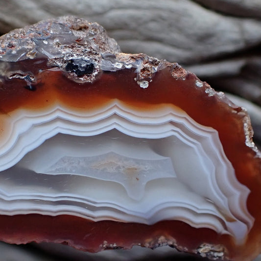 Close-up of the centre of a polished Malawi Ngabu agate showing the stunning 3D effect of ghost banding going out into a well formed flow channel