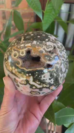 Ocean Jasper (Orbicular) Polished Sphere 115mm – in-hand video showing all sides and angles, orbicular patterning, open vug and bi-zonal colour, 8th Vein Marovato Madagascar | SKU OM00004