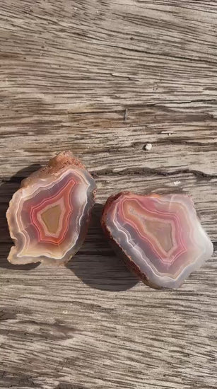 Matched Malawi agate pair 43 mm & 42 mm – rotating view, floaters, scalloped banding, carnelian-red tones | SKU 000492