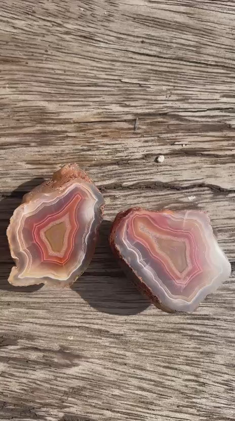 Matched Malawi agate pair 43 mm & 42 mm – rotating view, floaters, scalloped banding, carnelian-red tones | SKU 000492